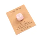 Close-up detail of a pink crystal pocket stone on a gift message card for special occasions. - Rose Quartz