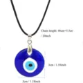 Evil eye pendant necklace with black cord, featuring a round blue glass amulet design. - Necklace With Leather Cord / 30mm