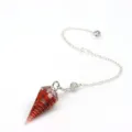 Detailed close-up view of red crystal stone resin hexagonal cone pendulum with silver chain. - Pendulum Pendant With Chain / Red Jasper