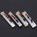 Closeup detail of natural selenite crystal wand with wire-wrapped colorful chakra beads. - Bead