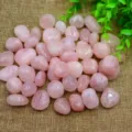 Close-up detail shot of natural tumbled pink rose quartz crystal stones for aromatherapy. - Rose Quartz
