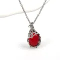 Detailed view of the vintage silver twig pendant necklace featuring a vivid red oval stone. - Red