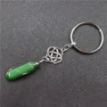 Close up detail of green crystal hexagonal pillar pendant key chain with wire wrap metal. - Celtic Knot + Green Aventurine