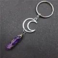 Crystal pendant keychain detail, wire-wrapped amethyst charm on textured background. - Moon + Amethyst