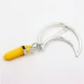 Detail view of a stylish crescent moon hair clip featuring a yellow crystal hexagonal pillar. - Topaz