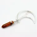 Detail view of the silver crescent moon hairpin featuring a hanging brown crystal hexagonal pillar charm. - Tiger Eye