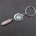 Detail shot of a natural rose quartz crystal wire-wrapped sun moon keychain pendant. - Sun Rose Quartz