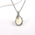 Detail shot of vintage bohemian style moonstone necklace with leaf vine pendant and silver chain. - Clear White