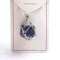 Detailed view of the natural crystal cage pendant necklace featuring a secure metal wire wrap. - Silver Mesh Bag with Stone / Blue Spot Stone