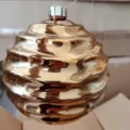 Golden electroplated Christmas ornament ball with unique wavy design for holiday tree decor. - Irregularly Shaped Ball / 14cm