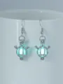 Trendige im Dunkeln leuchtende geflügelte Käfig Kugel Ohrringe modischer Schmuck - Engel + Blaugrün Leuchtend