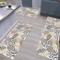 Detailed view of the kitchen floor mat set featuring botanical leaf print on wood floor. - HY Kitchen 3-Piece Set - 9