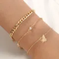 Elegante juego de pulseras doradas multicapa con cadena gruesa, strass y dije de mariposa. - Estilo Mariposa (NB616)