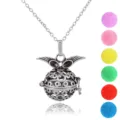 Detailed close-up of silver angel wings locket pendant with colorful diffuser balls. - Hollow Angel Wings Style (NX032)