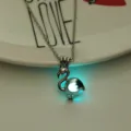Glow in the dark flamingo pendant necklace detail view, luminous animal charm jewelry accessory. - White Gold Chain with Blue Green Glow Bead