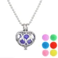 Detailed view of silver hollow heart cage pendant with colorful aromatherapy pom pom balls. - Hollow Heart Style (NX087)