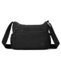 Sac bandoulière en nylon noir avec multiples poches zippées et sangle réglable. - Noir