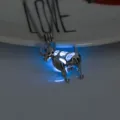 Close-up detail of the glowing ram pendant necklace in dark light showing blue light. - Sheep-Sky Blue Glow