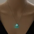 Detailed shot of a glowing dog pendant necklace, luminous hollow design, elegant silver chain. - Pug Dog-Blue Green Glow