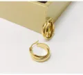 Gold interlocking hoop earrings detail view, showing exquisite metal texture and fine polish. - Gold No.1