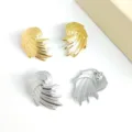 Chic metal stud earrings featuring unique swirled wing design with hammered texture, gold and silver. - Wing Steel