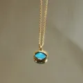 Minimalist gold chain necklace with a chic blue oval pendant, perfect for daily commuting wear. - Sky Blue