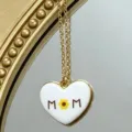 Stylish gold chain necklace featuring a white enamel heart pendant with MOM flower design. - Yellow Flower Heart