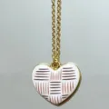 Gold chain necklace featuring a white striped heart pendant, elegant fashion jewelry variant. - Outline Heart