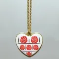 Gold chain necklace with a white heart pendant featuring red rose patterns for daily fashion. - Red Rose Heart