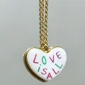 Gold chain necklace featuring a white heart pendant with love text design variant. - Green Purple Heart