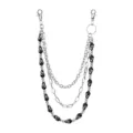 Detailed view of punk style triple layer pants chain with silver metal links and black skulls. - Black