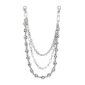 Detailed view of a multi-layer metal pants chain with sparkling football beads and lobster clasps. - Black and White Football Style