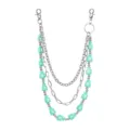 Detailed view of the multi-layer metal pants chain with mint green money bag charms. - Emerald Green