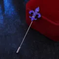Detail shot of the metal fleur-de-lis lapel pin with sparkling blue rhinestones for men suits. - Blue Rhinestone (Black Base)