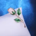 Pink fabric rose brooch with green enamel leaves, elegant metallic stem accessory for women. - Apricot