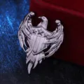 Close-up detail of vintage silver eagle shield brooch, retro metallic pin badge - Gunmetal