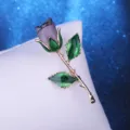 Elegant fabric rose brooch with green leaves and gold-tone stem for evening party wear. - Gray