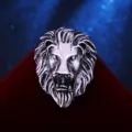 Close-up detail shot of vintage silver lion head brooch, fine metal texture piece. - Antique Silver