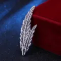 Detailed shot of vintage silver feather brooch accessory showing fine texture design - Antique Silver
