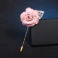 Exquisite pink fabric rose lapel pin detail, featuring gold leaf and long metal pin. - Pink