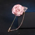 Exquisite detail of pink fabric camellia flower brooch with metal leaf and tassel chain pin. - Pink