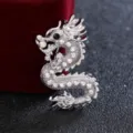 Detailed close-up view of the sparkling silver dragon brooch with clear crystal rhinestones. - Silver