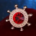 Vintage ship helm lapel pin with red rhinestone crystal gold tone metal suit collar brooch. - Red
