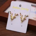 Gold deer head stud earrings mounted on a white card, vintage animal jewelry for daily wear. - Deer Head Lapel Pins Pair / Gold
