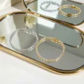 Bracciali minimalisti in oro e argento con zirconi cubici lucidi su sfondo specchio - Bracciale Tennis con Brillanti / Oro/Argento