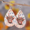 Close up detail of teardrop leather earrings with highland cow and floral pattern. - Style 1035