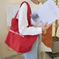Red canvas tote bag for women, large capacity shoulder bag with stylish letter print. - True Red