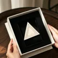 Elegant beige triangular decorative piece with scalloped edge in luxury gift box display. - Lace Triangle