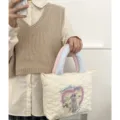Quilted tote bag with cute dog graphic and fuzzy handles, stylish and spacious for daily use. - Off White