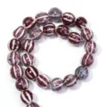 Close-up detail of glazed ceramic striped round beads for DIY jewelry making and craft projects. - Striped Pumpkin Round Bead (T7410) / Burgundy